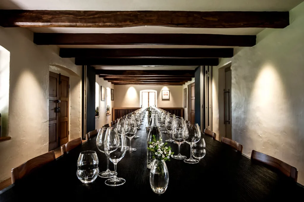 Rows of glasses set up on a long wooden table in a private Torbreck tasting room