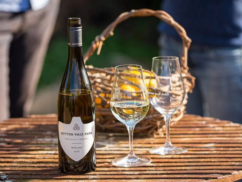 Two glasses and a bottle of Riesling on a small wooden table at Hutton Vale Farm