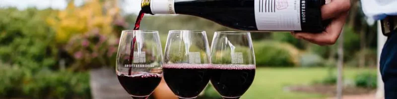 Three glasses of red wine being poured in the Shottesbrooke beer garden