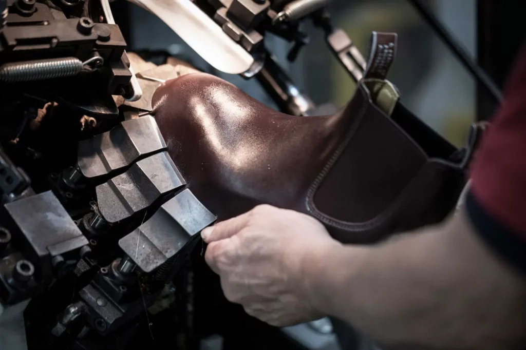 Close up of R.M.Williams employee repairing a boot