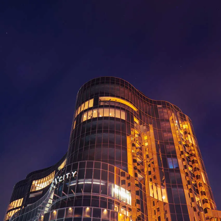 Low angle view of Eos by SkyCity illuminated at night