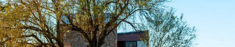 Two guests drinking wine outside of Hutton Vale Farm’s JHA Stone Cellar
