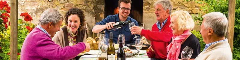 People enjoying wine and food in the courtyard of Hutton Vale Farm